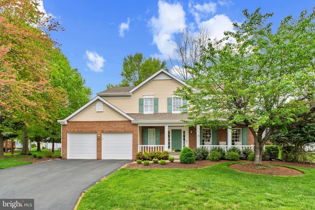 traditional home featuring an attached garage, a front lawn, brick siding, a porch, and driveway