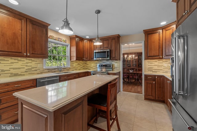 kitchen with a sink, appliances with stainless steel finishes, tasteful backsplash, and recessed lighting