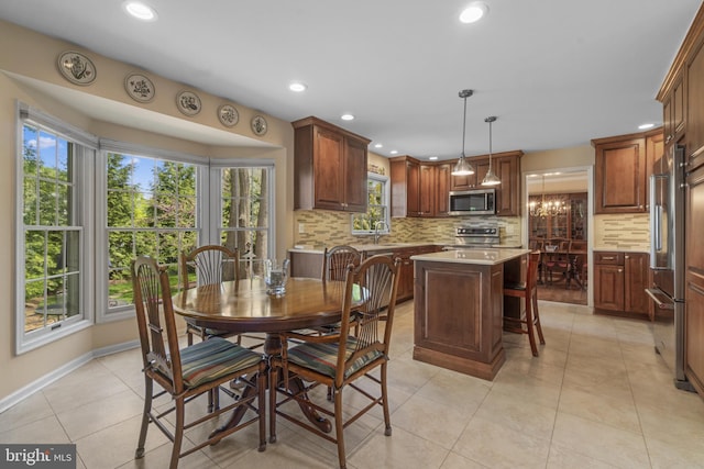 dining room with recessed lighting, baseboards, and light tile patterned floors