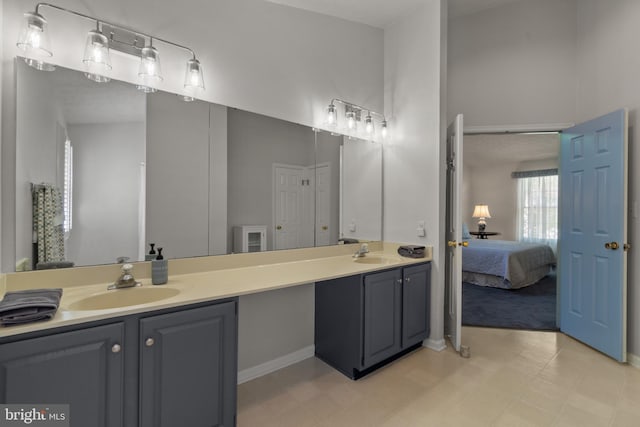 full bath with a sink, ensuite bathroom, and double vanity