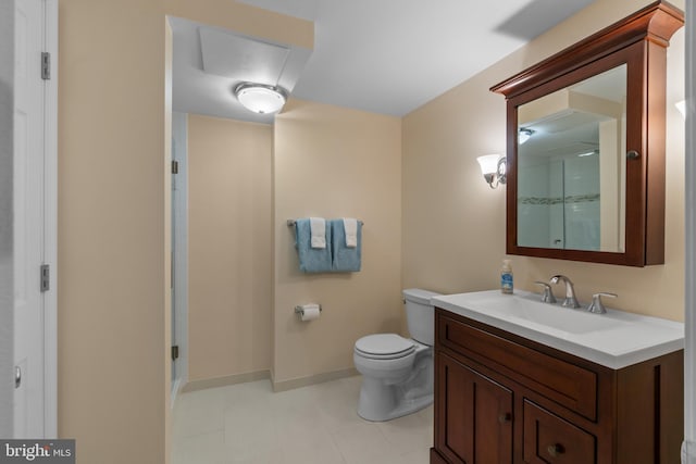 bathroom with vanity, baseboards, a shower with shower door, and toilet