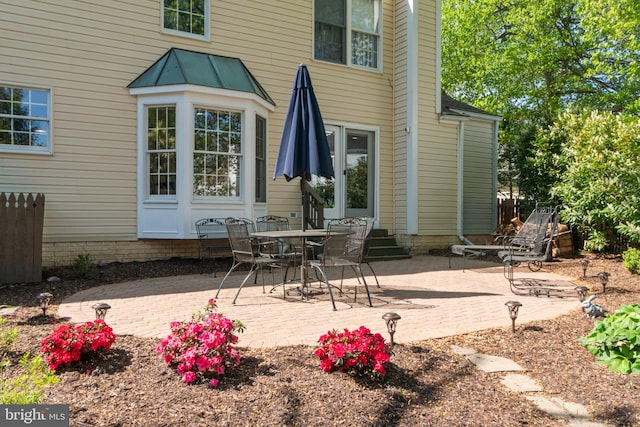 back of house featuring entry steps and a patio area