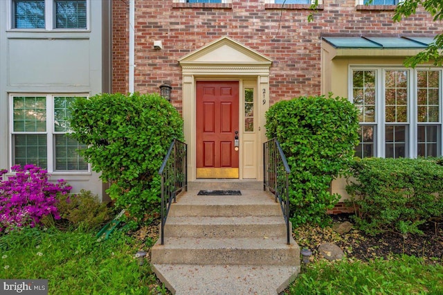 property entrance with brick siding