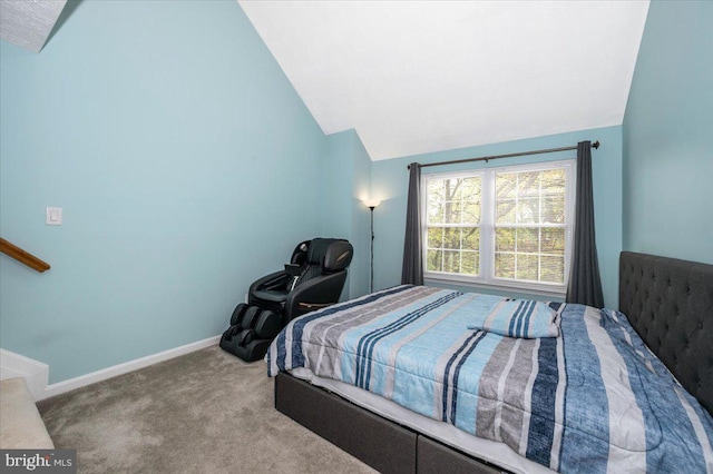 carpeted bedroom featuring lofted ceiling and baseboards