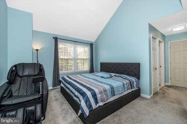 carpeted bedroom with baseboards and lofted ceiling