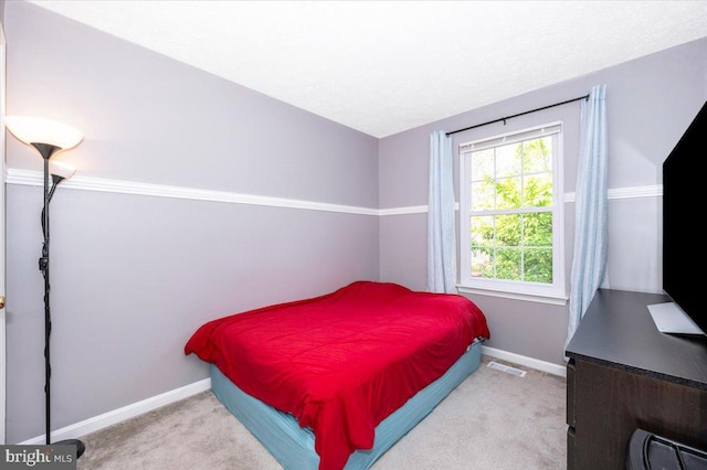 bedroom featuring carpet flooring, visible vents, and baseboards