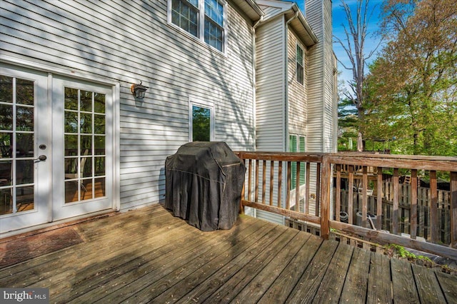 wooden deck featuring a grill