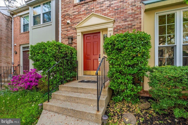 property entrance featuring brick siding