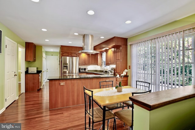 dining area featuring a toaster, wood finished floors, and recessed lighting