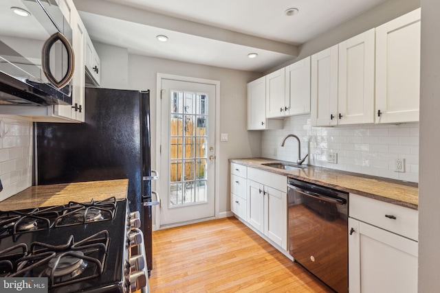 1720 Alter St, Philadelphia, PA 19146 - kitchen featuring white cabinets, dishwasher, a sink, light wood-type flooring, and gas stove