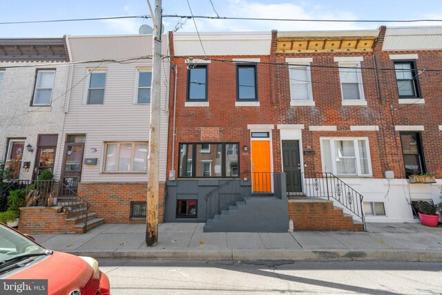 townhome / multi-family property with brick siding