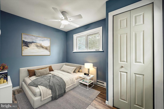 696 Burger Hollow Rd, Kunkletown, PA 18058 - bedroom with wood finished floors, a ceiling fan, a baseboard heating unit, a closet, and baseboards