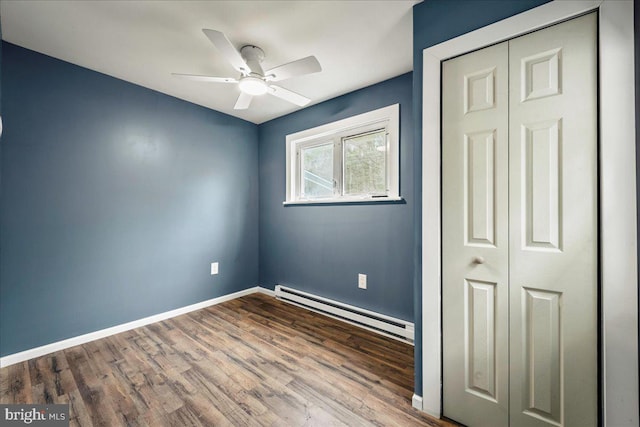 696 Burger Hollow Rd, Kunkletown, PA 18058 - unfurnished bedroom with wood finished floors, a ceiling fan, a closet, baseboards, and baseboard heating