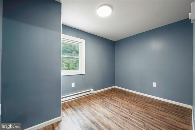 696 Burger Hollow Rd, Kunkletown, PA 18058 - unfurnished room featuring baseboards, wood finished floors, and a baseboard radiator