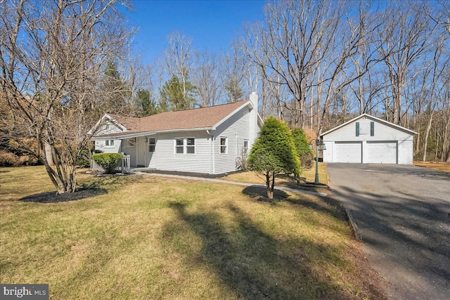 696 Burger Hollow Rd, Kunkletown, PA 18058 - view of front of property featuring a chimney, an outdoor structure, a front yard, and a garage