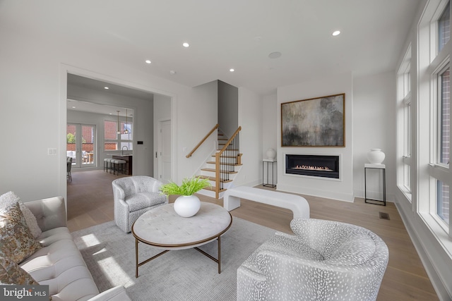 227 S Union St, Alexandria, VA 22314 - living room featuring a glass covered fireplace, recessed lighting, baseboards, wood finished floors, and stairway