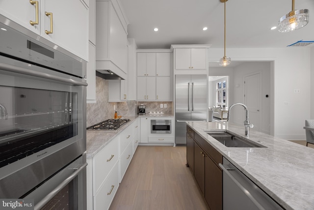227 S Union St, Alexandria, VA 22314 - kitchen featuring a sink, light wood-style flooring, stainless steel appliances, recessed lighting, and tasteful backsplash