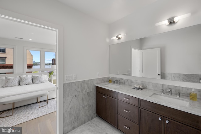 227 S Union St, Alexandria, VA 22314 - full bathroom featuring a sink, tile walls, wainscoting, and double vanity
