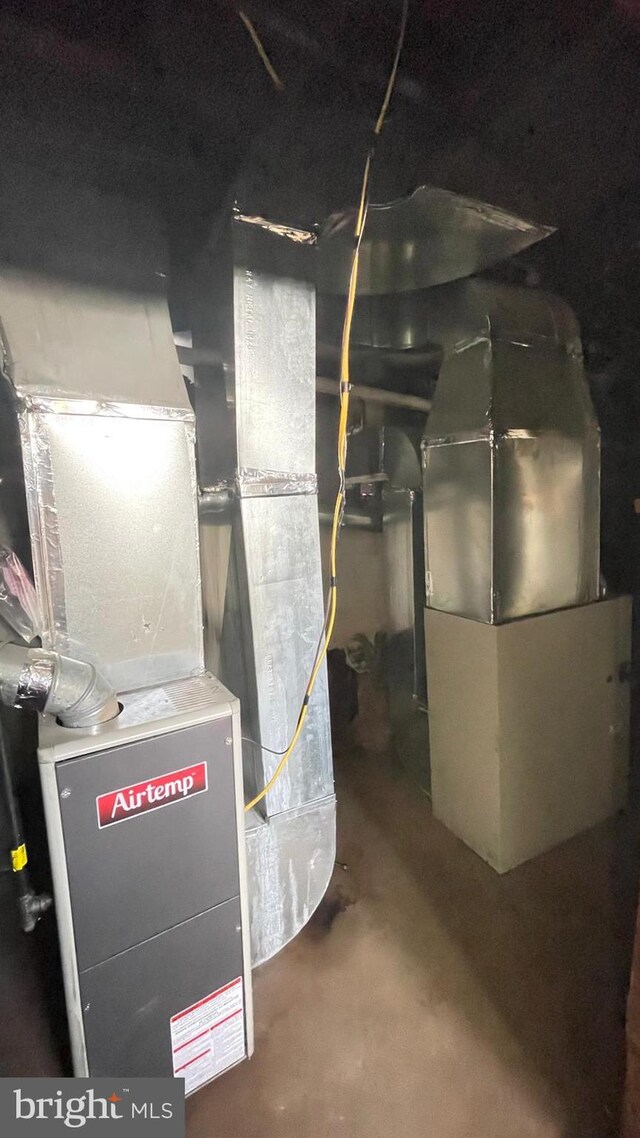 utility room featuring heating unit