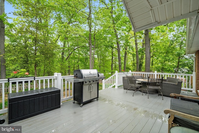 wooden terrace featuring outdoor dining area and area for grilling
