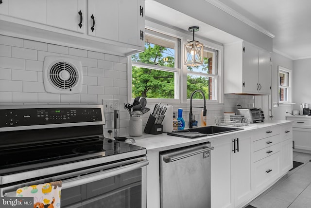 kitchen featuring crown molding, light tile patterned flooring, a sink, backsplash, and stainless steel appliances
