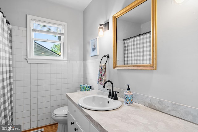 bathroom featuring vanity, a shower with shower curtain, and toilet