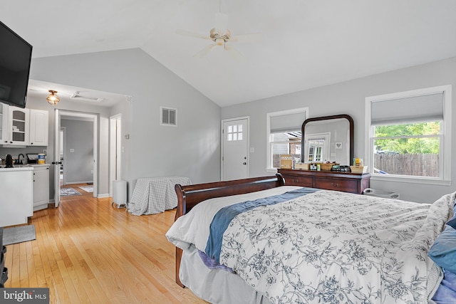 bedroom with visible vents, light wood finished floors, ceiling fan, and vaulted ceiling