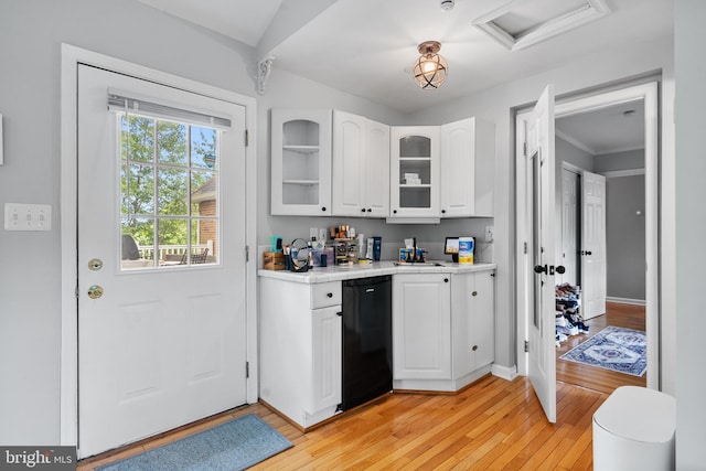 kitchen featuring light countertops, light wood-type flooring, white cabinetry, and dishwasher