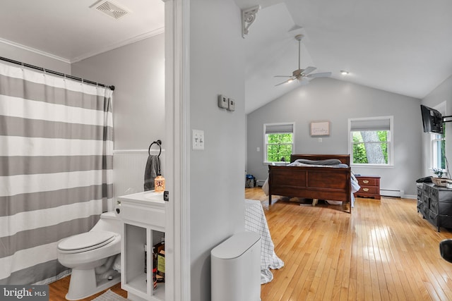 bedroom featuring a baseboard radiator, wood-type flooring, lofted ceiling, and visible vents