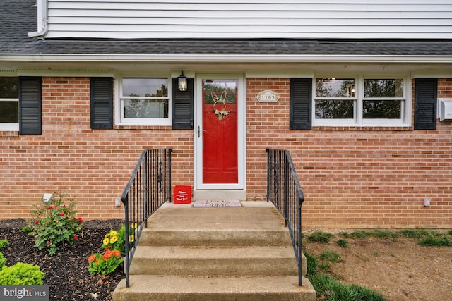 view of exterior entry with brick siding