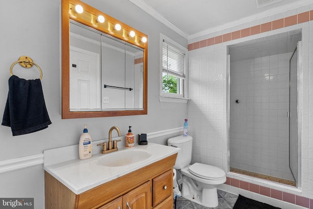 full bathroom featuring vanity, crown molding, tile patterned flooring, toilet, and a tile shower
