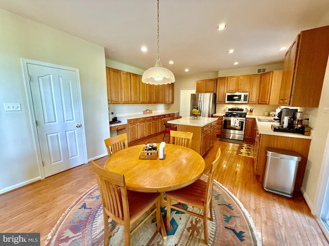 14100 Twisting Ln, Dayton, MD 21036 - kitchen with stainless steel appliances, a kitchen island, recessed lighting, light countertops, and light wood-style flooring