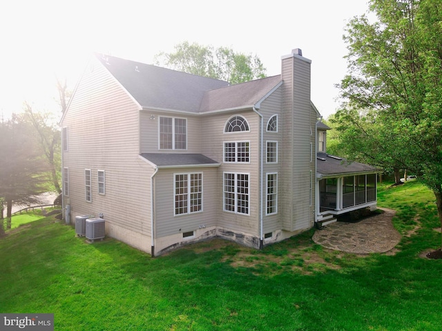 14100 Twisting Ln, Dayton, MD 21036 - back of house featuring a chimney, a sunroom, a yard, and central AC