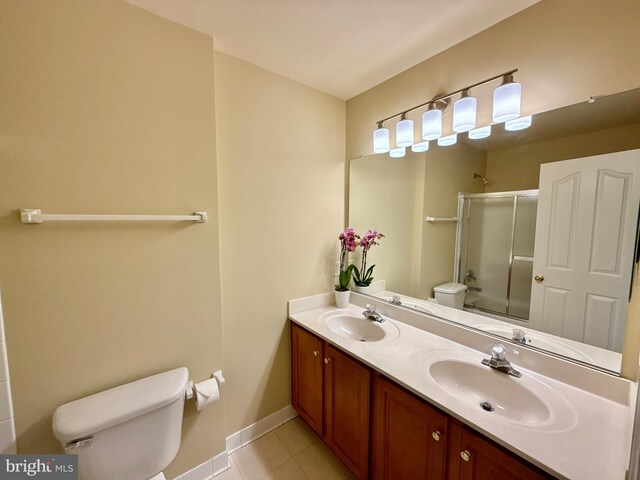 14100 Twisting Ln, Dayton, MD 21036 - bathroom with toilet, a shower with shower door, tile patterned flooring, double vanity, and baseboards