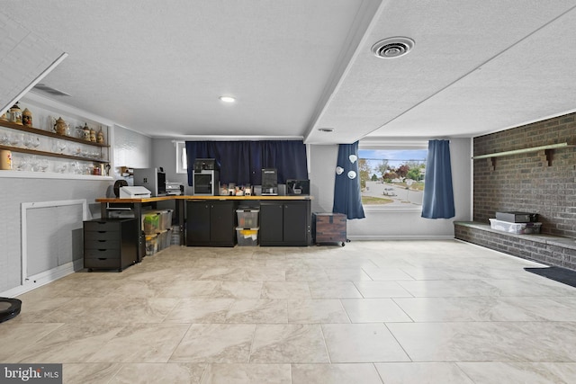 bar with a textured ceiling, baseboards, and visible vents