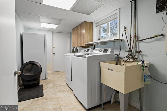 laundry area featuring a sink and independent washer and dryer