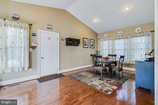 dining area with baseboards, visible vents, wood finished floors, and plenty of natural light