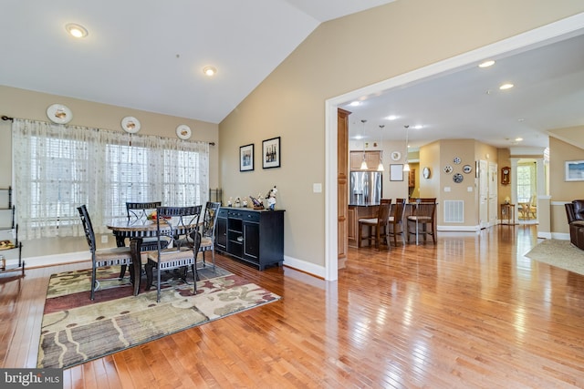 dining room featuring recessed lighting, hardwood / wood-style flooring, visible vents, baseboards, and lofted ceiling