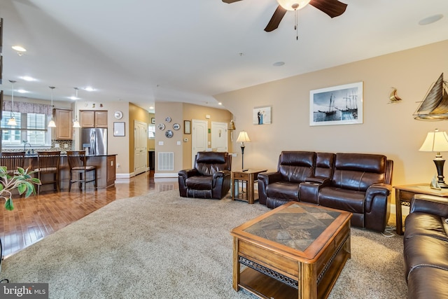 living room featuring visible vents, wood finished floors, a ceiling fan, and recessed lighting