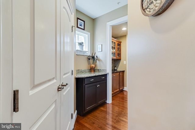 corridor featuring dark wood finished floors