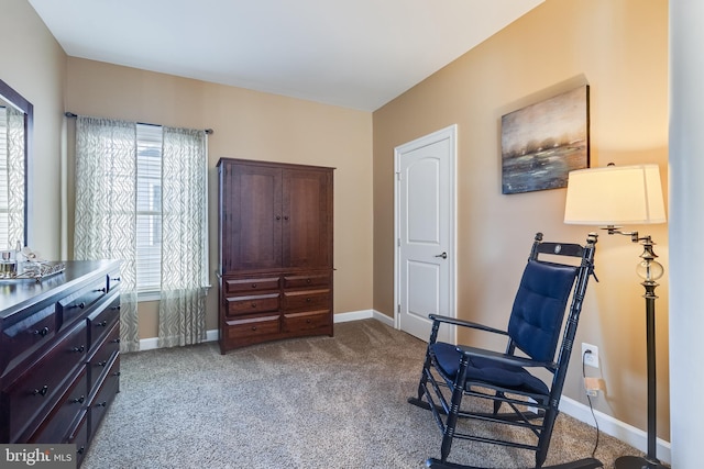 sitting room featuring carpet and baseboards