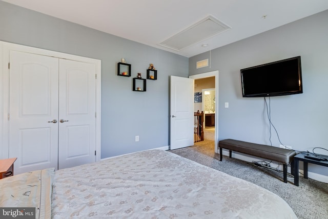 carpeted bedroom featuring attic access, a closet, and baseboards