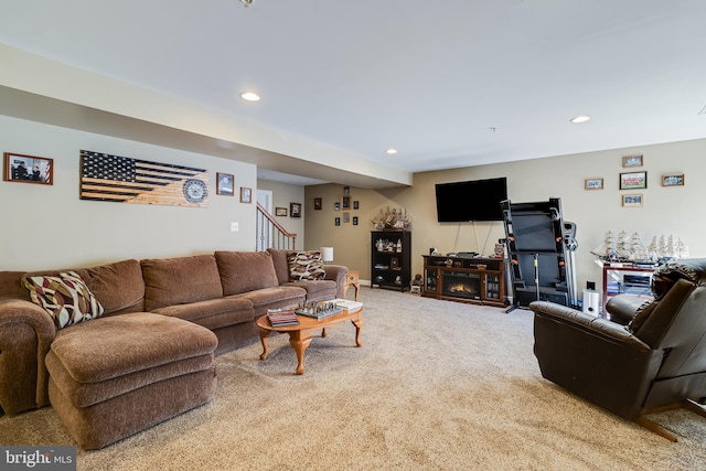 carpeted living room featuring recessed lighting and stairs