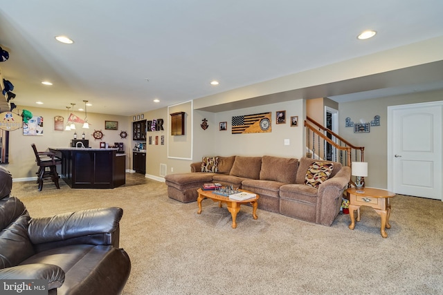 living room featuring recessed lighting, indoor wet bar, stairway, and carpet