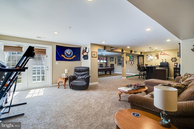 carpeted living area with baseboards, recessed lighting, and indoor wet bar