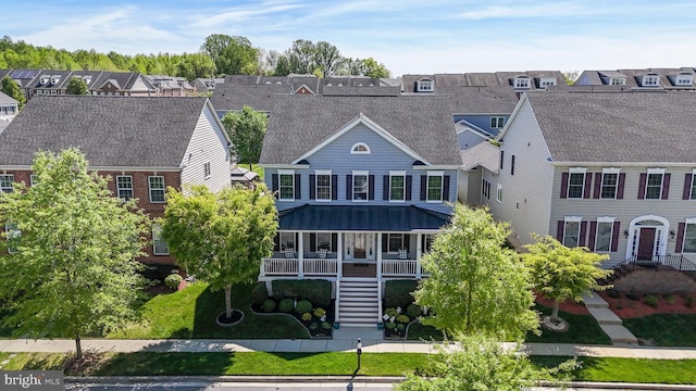 view of front of property featuring a residential view, stairs, and covered porch