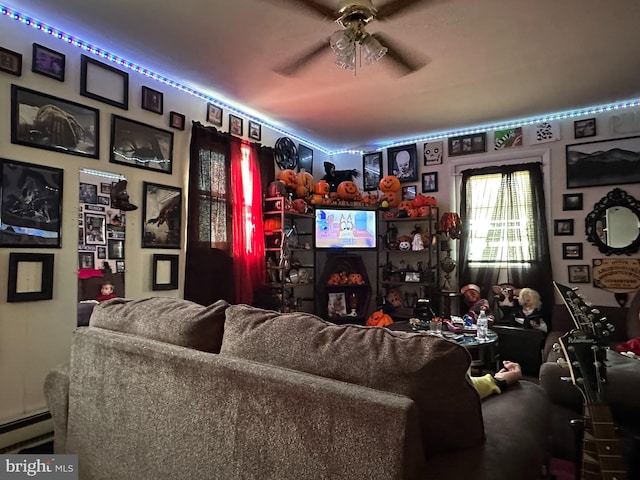 living area with ceiling fan and a baseboard radiator
