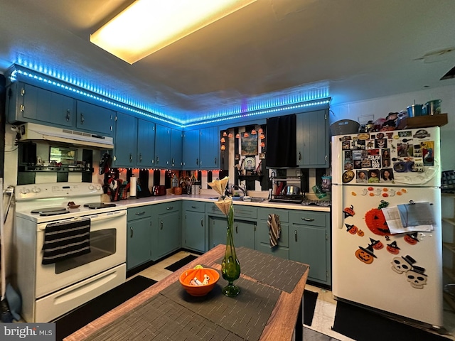 kitchen with a sink, light countertops, under cabinet range hood, light floors, and white appliances
