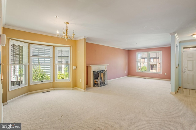 unfurnished living room featuring carpet floors, baseboards, a chandelier, and ornamental molding