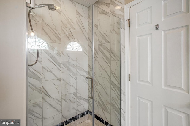 full bathroom featuring a marble finish shower